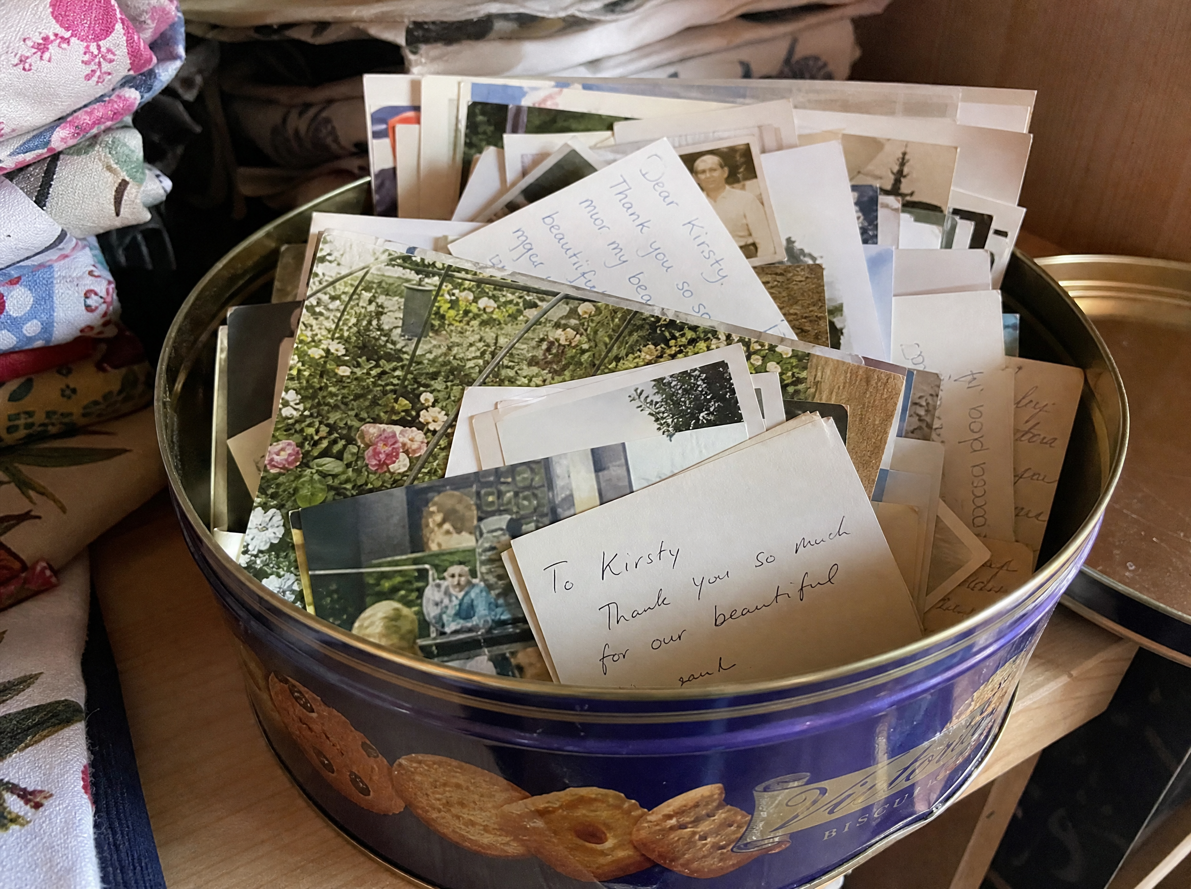 Rosie's biscuit tin full of customer notes and photos sent in over the years